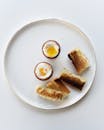 Soft-boiled eggs with sliced toast served on a minimalist white plate, ideal for breakfast.