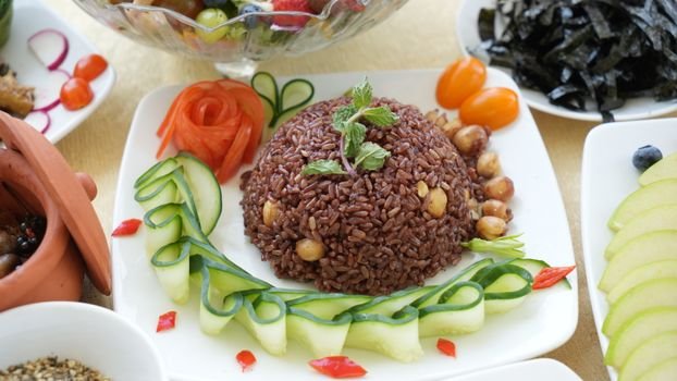 Appetizing brown rice garnished with fresh vegetables, exuding vibrant and healthy vibes.